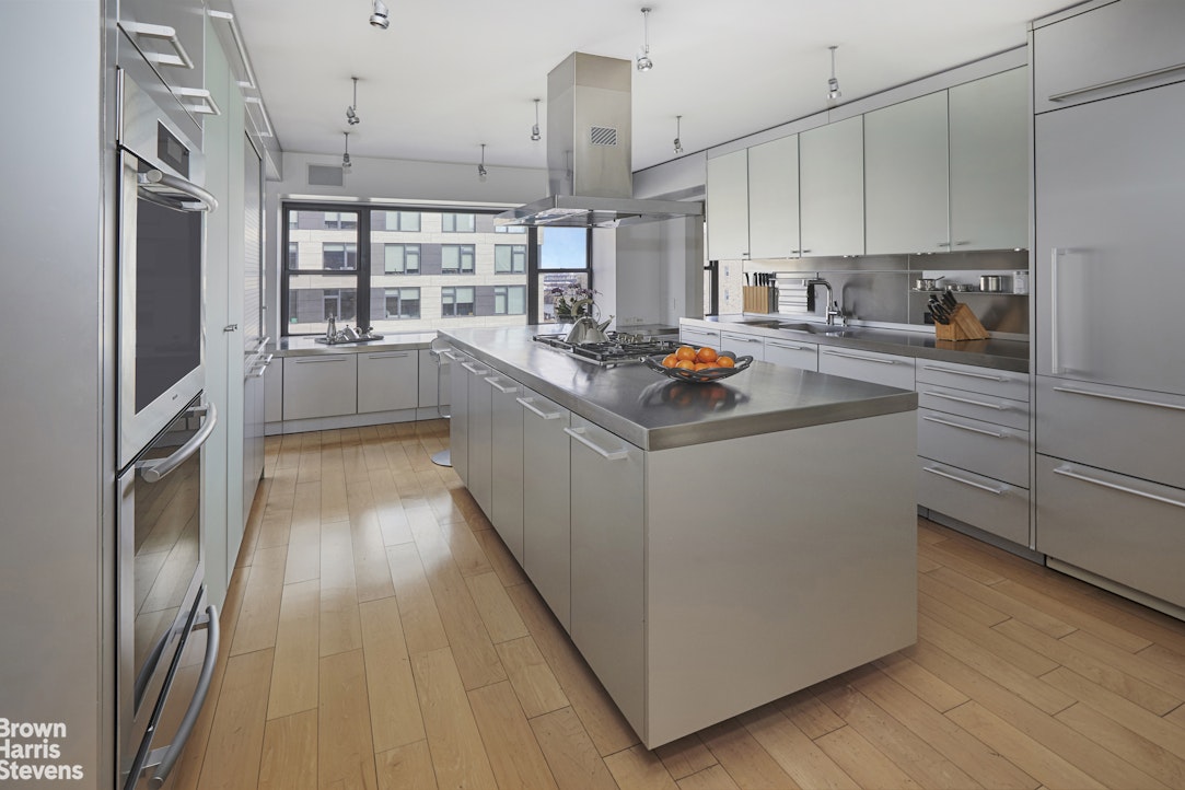 510 East 86th Street, Unit 17C Manhattan, NY 10028 - Photo 7 of 17 a kitchen that has a lot of cabinets and wooden floor