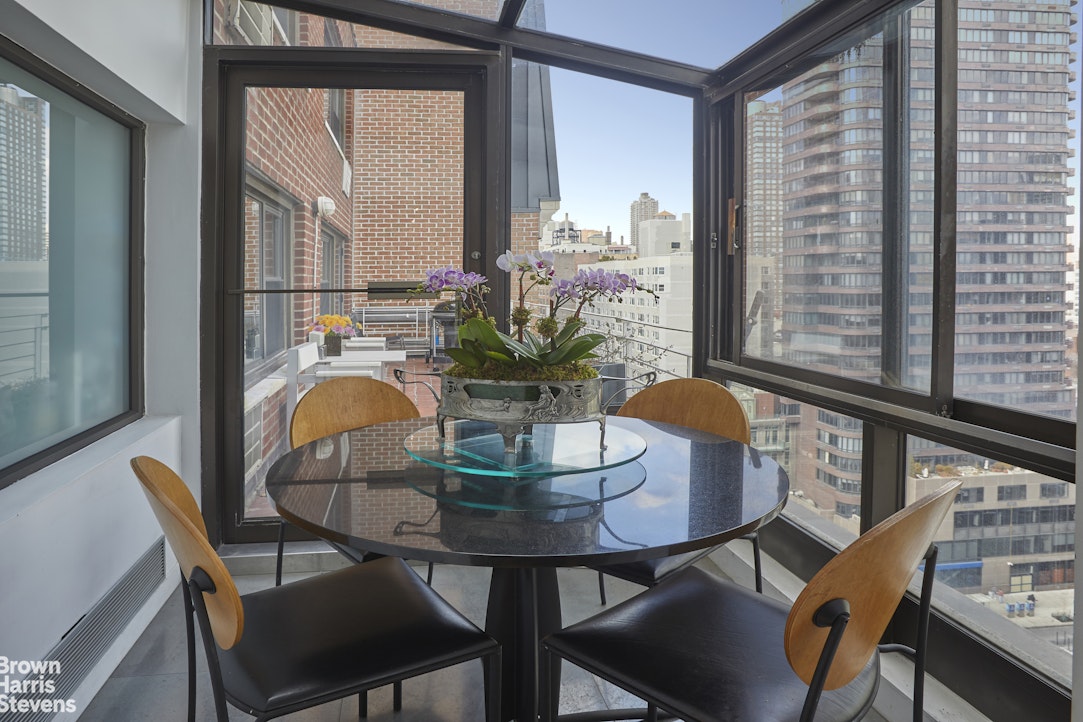 510 East 86th Street, Unit 17C Manhattan, NY 10028 - Photo 8 of 17 a dining room with furniture and wooden floor