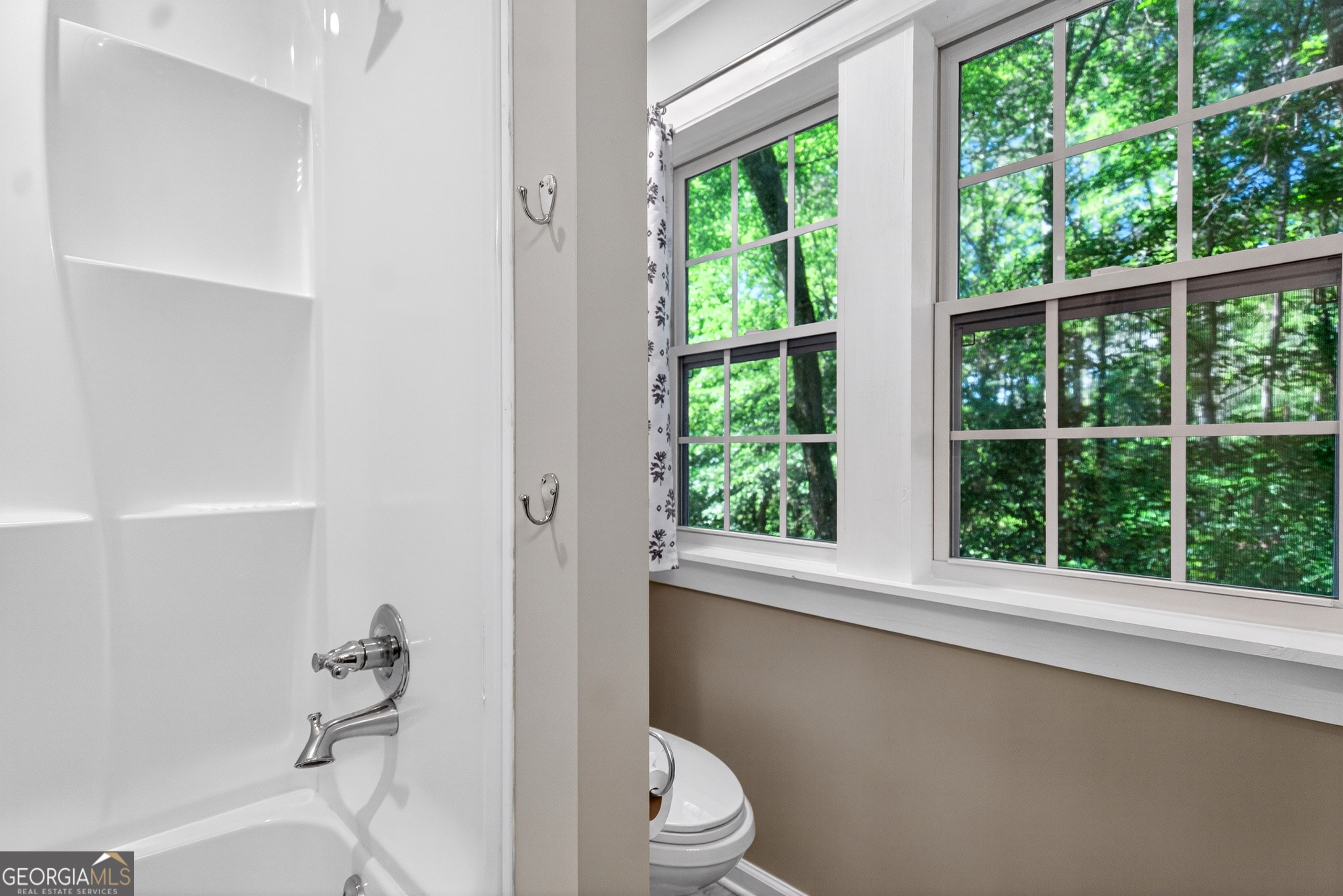 4656 Greenville Road LaGrange, GA 30241 - Photo 24 of 34 a bathroom with a toilet a sink and a window