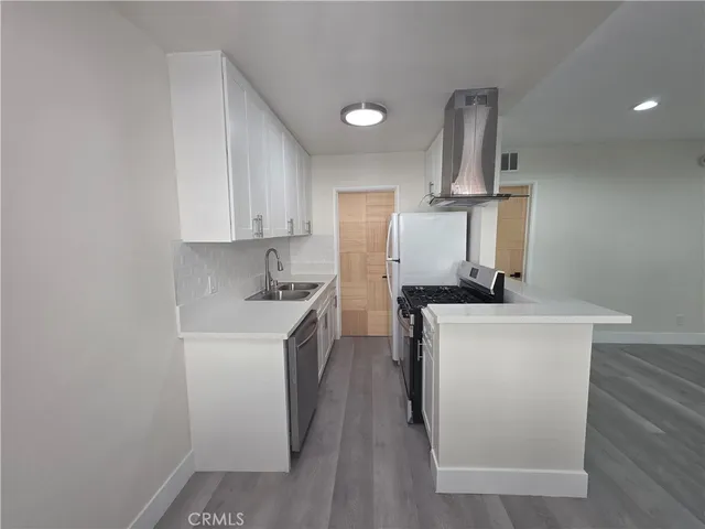 a kitchen with a sink a stove and refrigerator