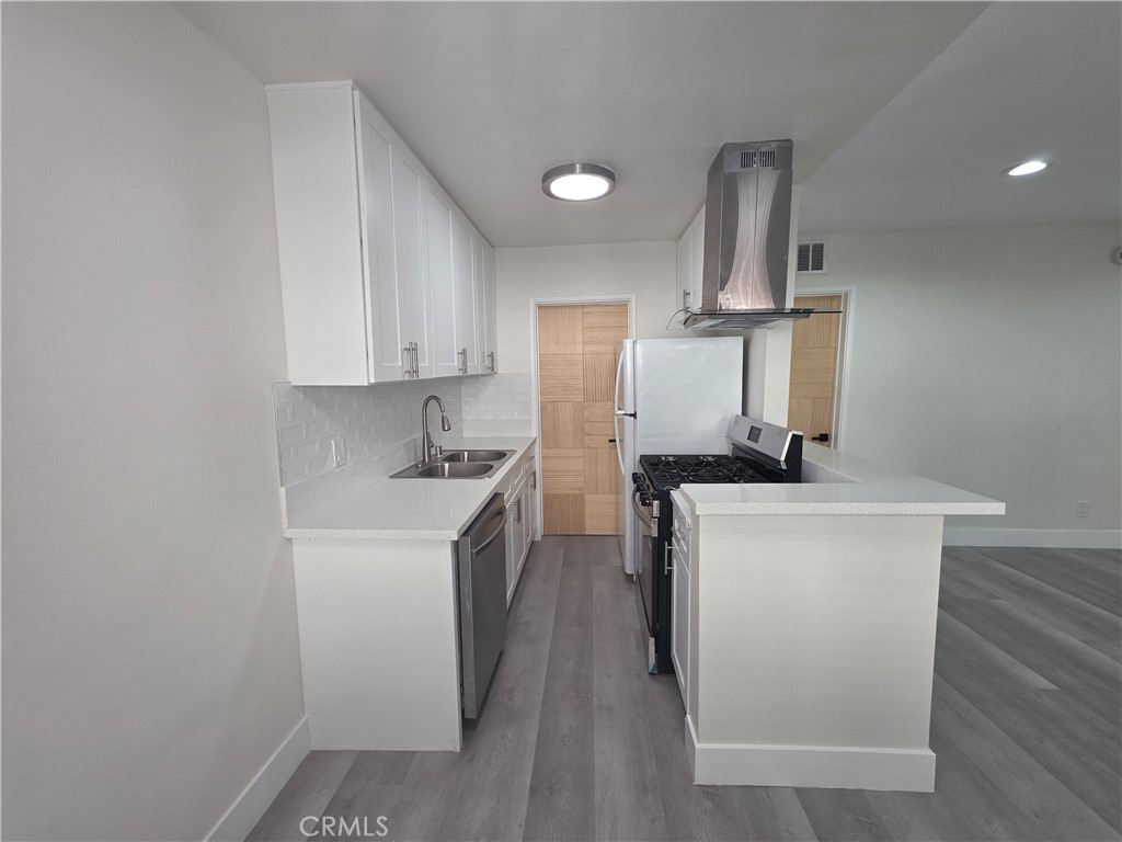 4436 Ventura Canyon Avenue Sherman Oaks, CA 91423 - Photo 4 of 13 a kitchen with a sink a stove and refrigerator
