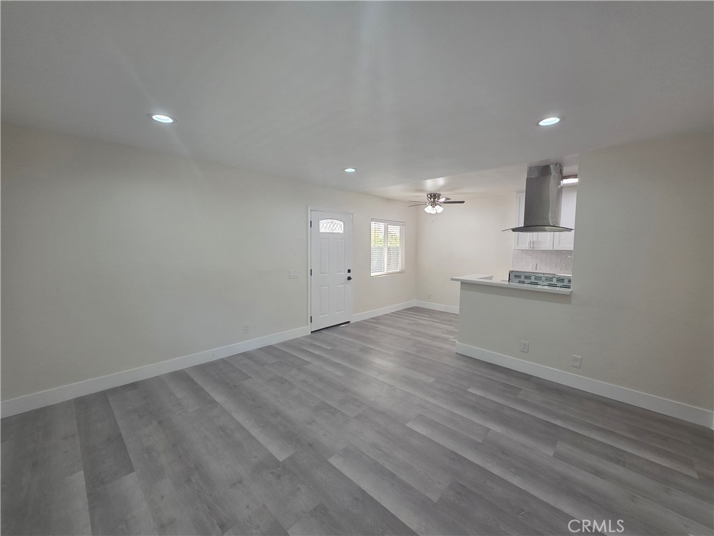4436 Ventura Canyon Avenue Sherman Oaks, CA 91423 - Photo 5 of 13 an empty room with wooden floor and windows