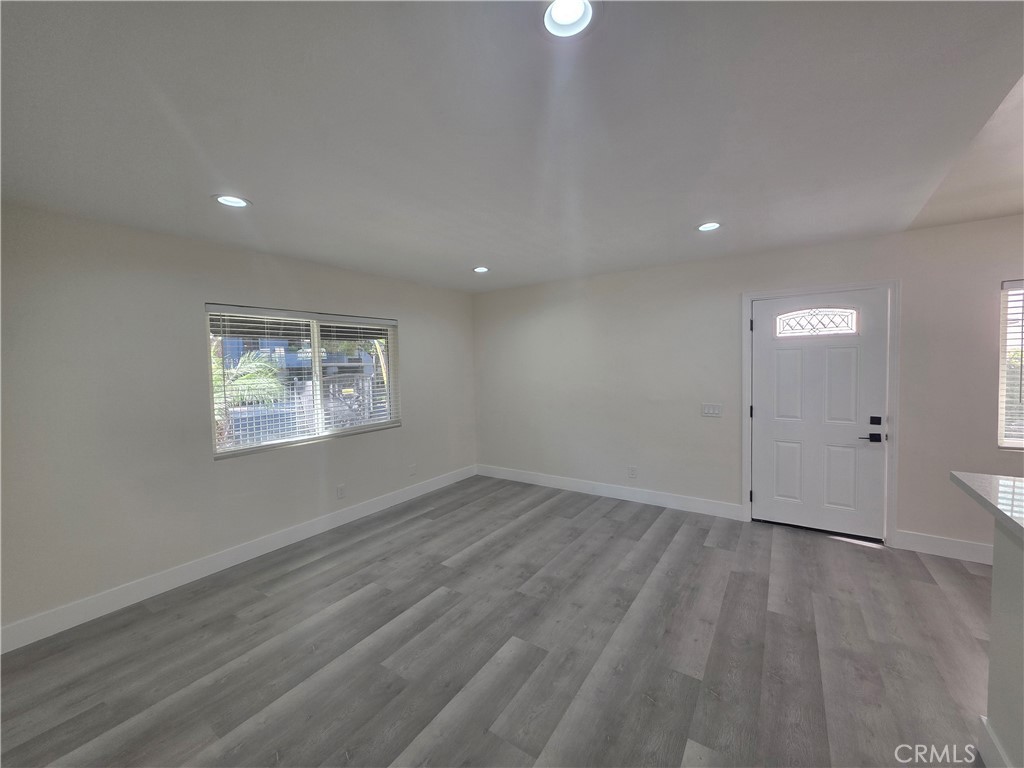 4436 Ventura Canyon Avenue Sherman Oaks, CA 91423 - Photo 7 of 13 an empty room with wooden floor and windows