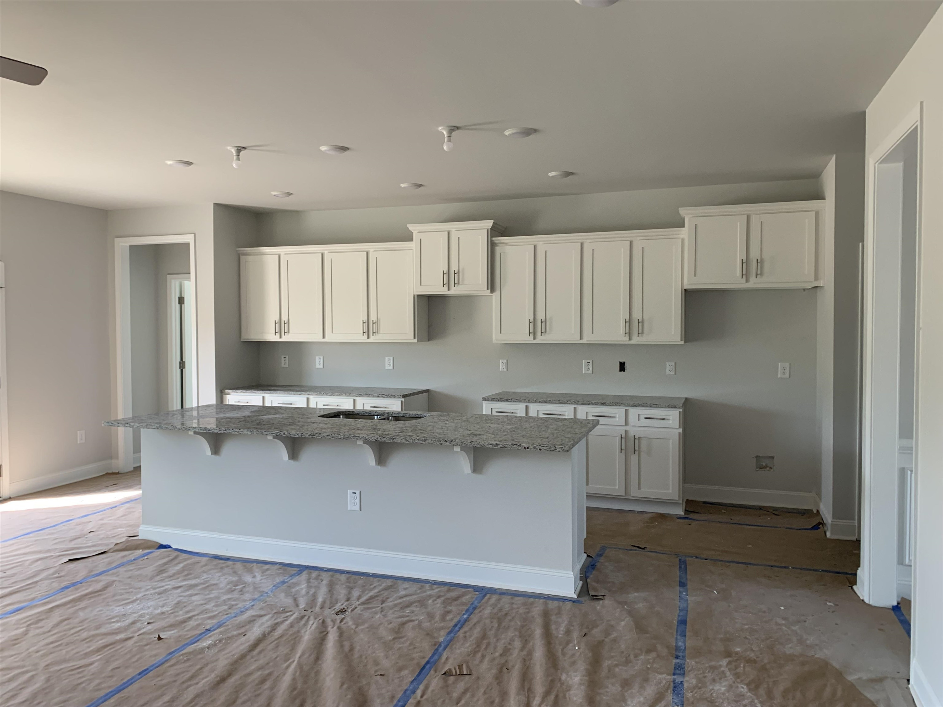 8566 Shallow Crk Trail Bailey, NC 27807 - Photo 3 of 20 a kitchen with kitchen island a sink a stove a refrigerator and white cabinets