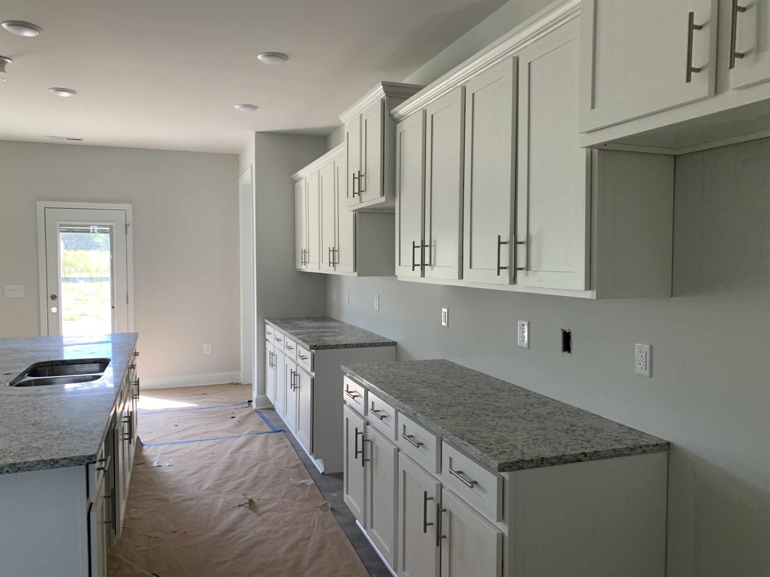 8566 Shallow Crk Trail Bailey, NC 27807 - Photo 8 of 20 a kitchen with granite countertop a sink and dishwasher a stove with wooden cabinets
