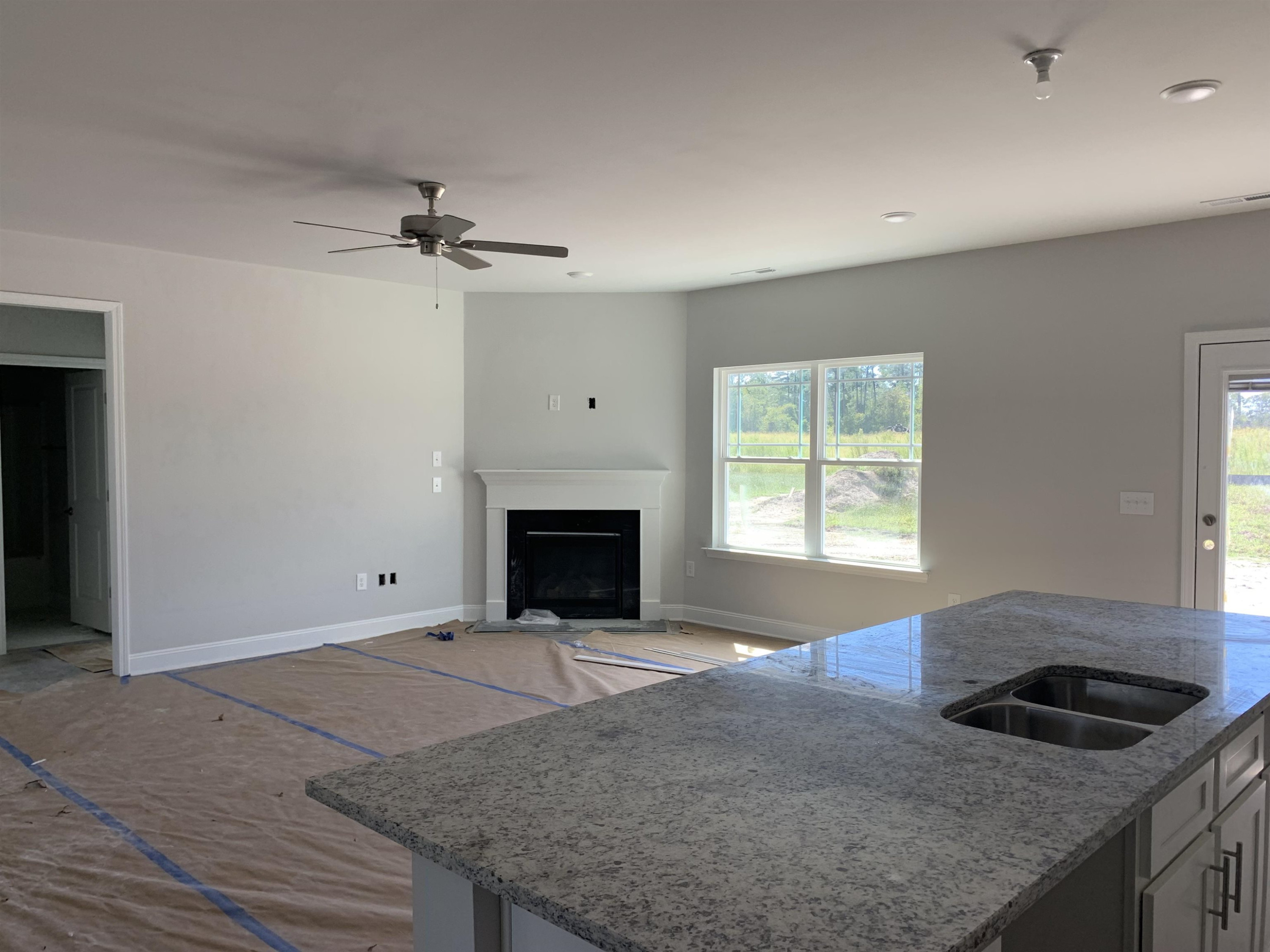 8566 Shallow Crk Trail Bailey, NC 27807 - Photo 9 of 20 a kitchen with granite countertop a stove a sink and a refrigerator
