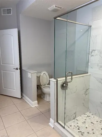 a bathroom with a shower and a sink