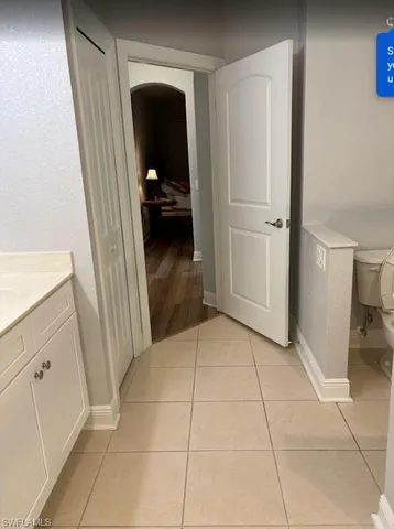 a view of a hallway to rooms and stairs