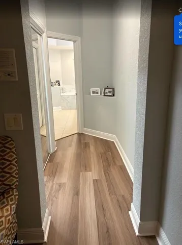 a view of a bedroom with bed and wooden floor