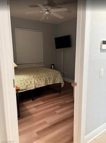a bathroom with a granite countertop toilet a sink and a mirror