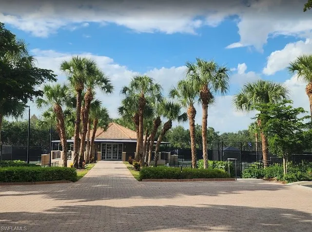 a view of a house with a yard and a street