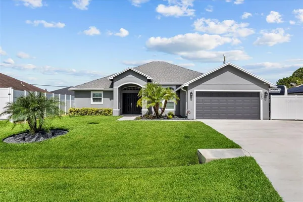 a front view of a house with a yard and garage