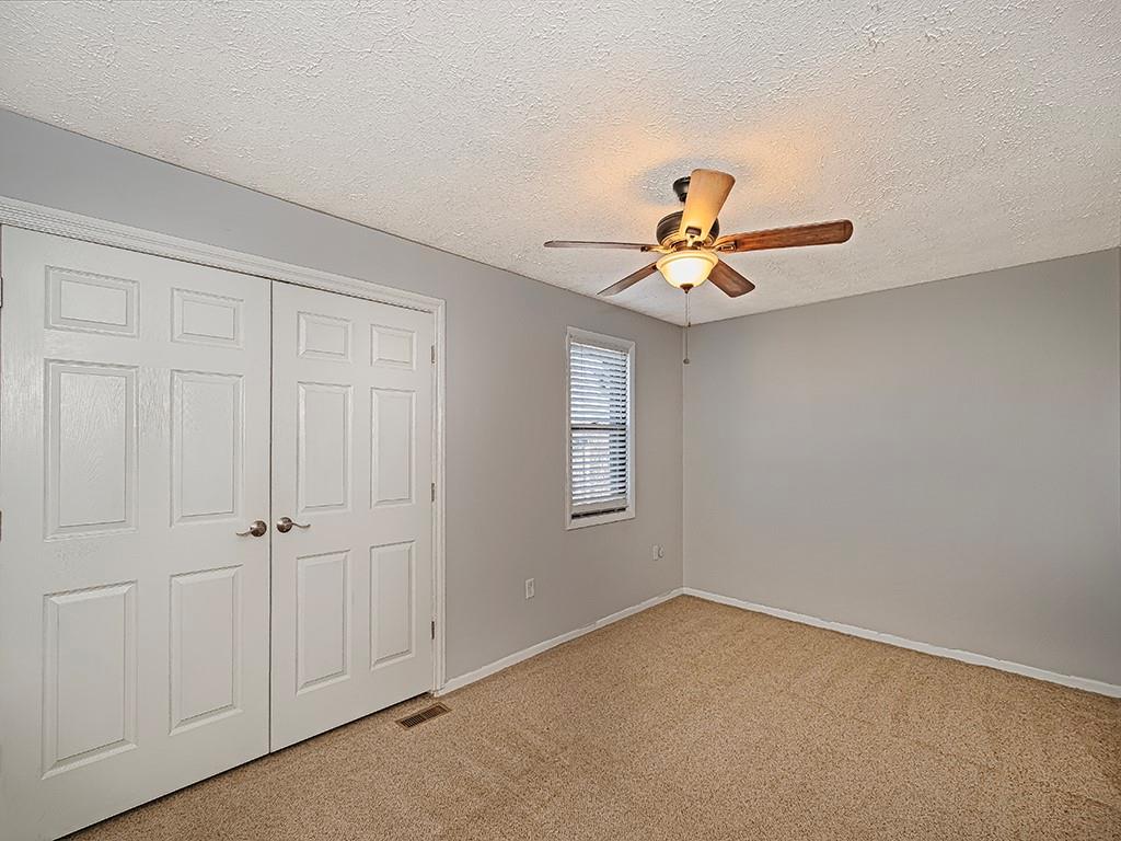 120 Forest Drive Seven Fields, PA 16046 - Photo 15 of 24 an empty room with window and ceiling fan
