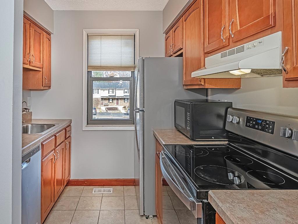 120 Forest Drive Seven Fields, PA 16046 - Photo 7 of 24 a kitchen with a stove and a microwave
