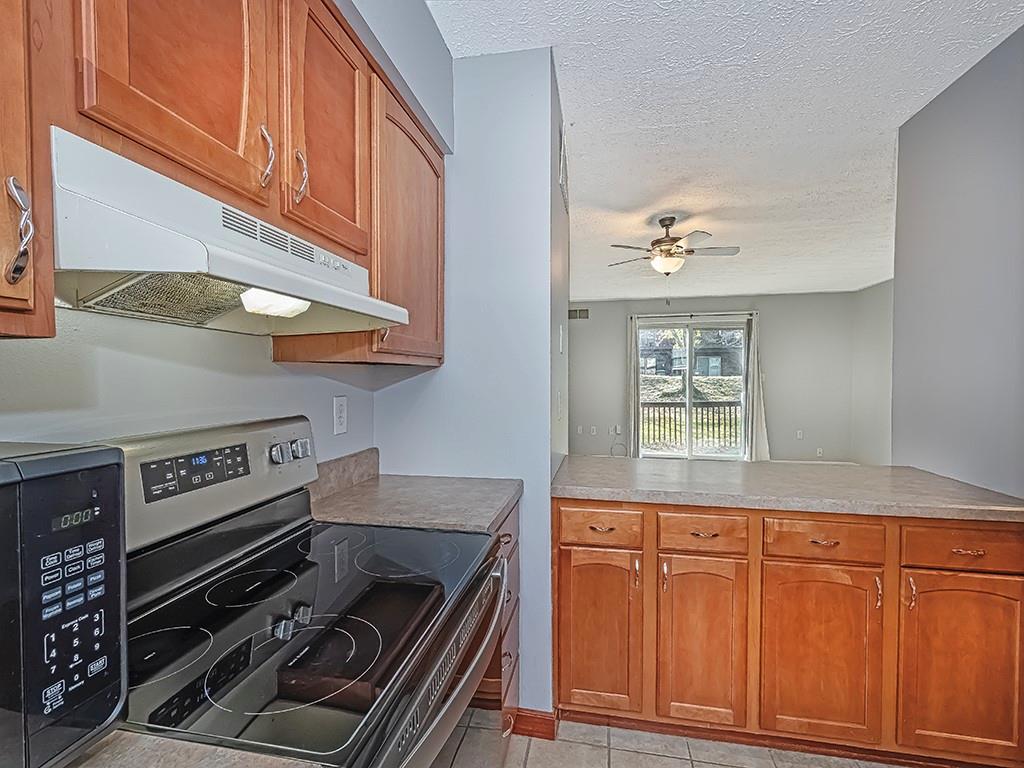 120 Forest Drive Seven Fields, PA 16046 - Photo 9 of 24 a kitchen with granite countertop a stove and a sink