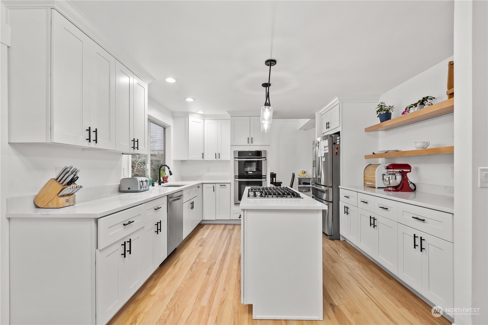 10411 Northeast 152nd Place Bothell, WA 98011 - Photo 12 of 38 a kitchen with white cabinets sink and white appliances
