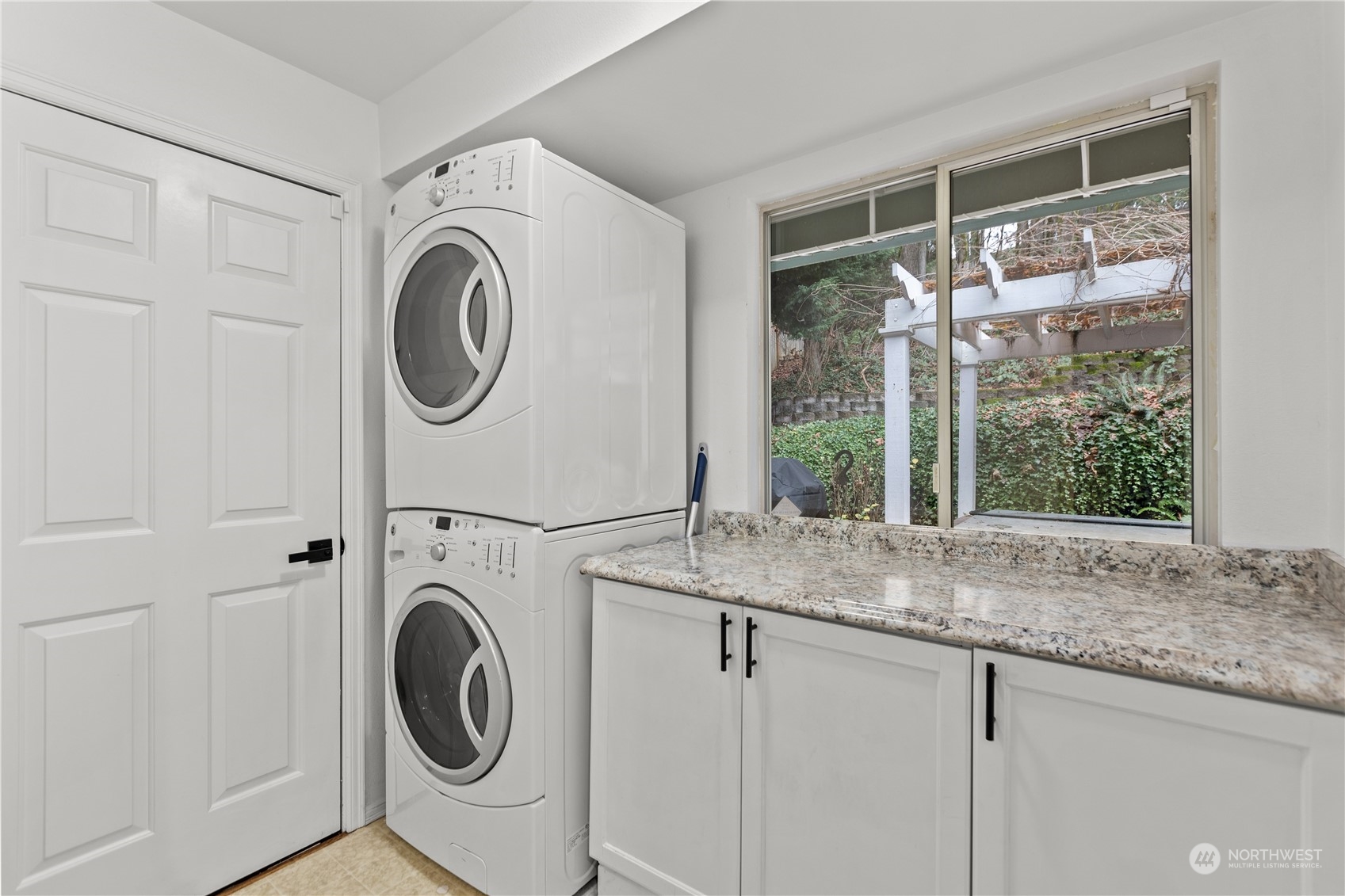10411 Northeast 152nd Place Bothell, WA 98011 - Photo 13 of 38 a view of a storage and utility room with washer and dryer