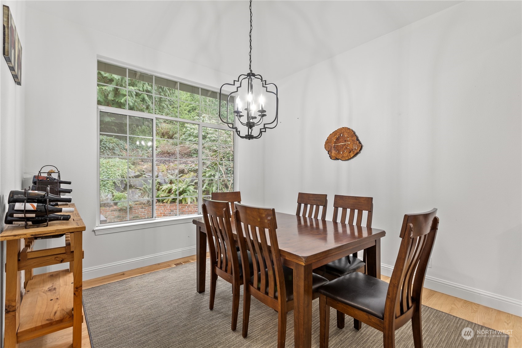 10411 Northeast 152nd Place Bothell, WA 98011 - Photo 17 of 38 a view of a dining room with furniture a chandelier and wooden floor