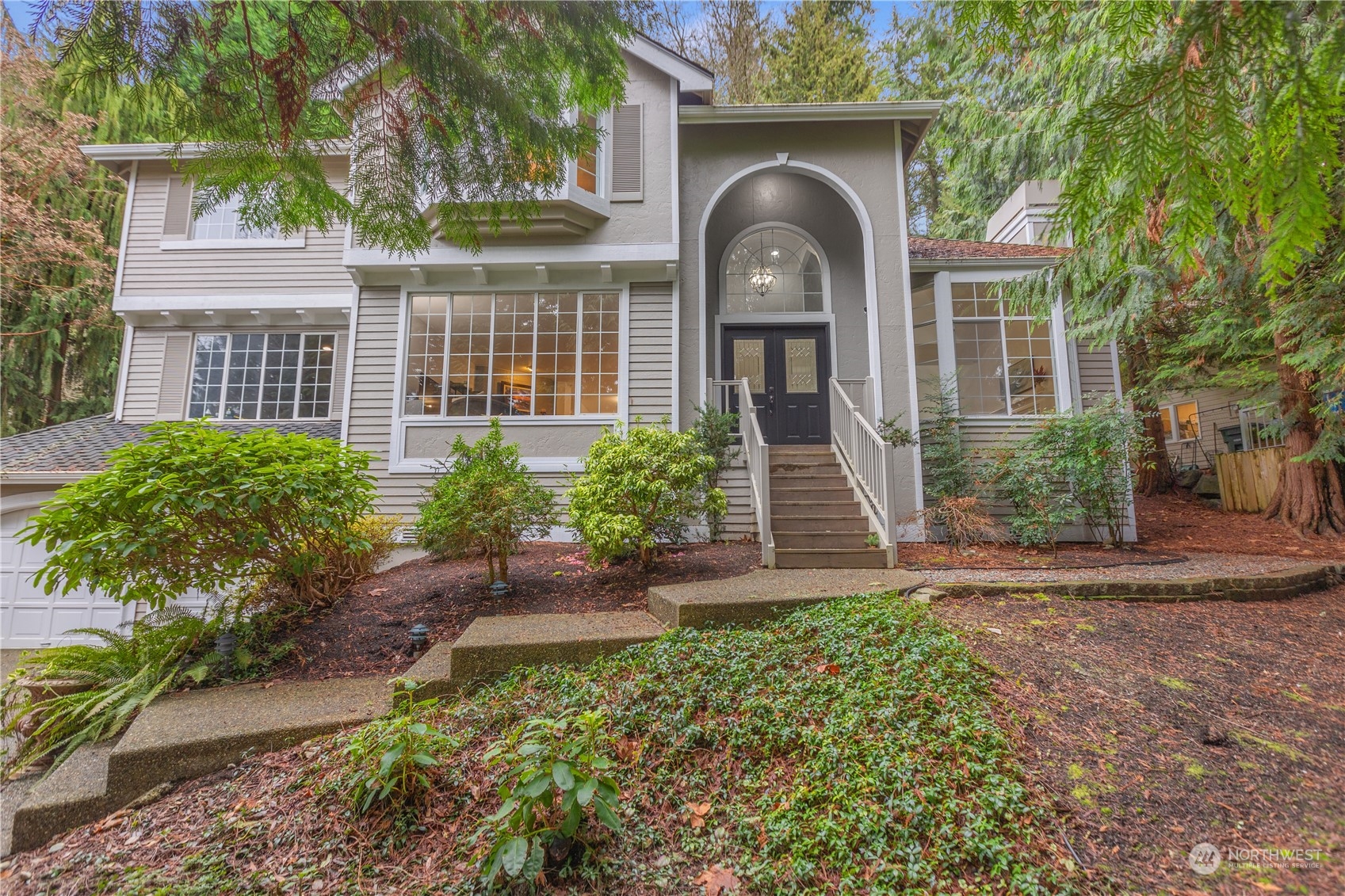 10411 Northeast 152nd Place Bothell, WA 98011 - Photo 2 of 38 a front view of a house with garden
