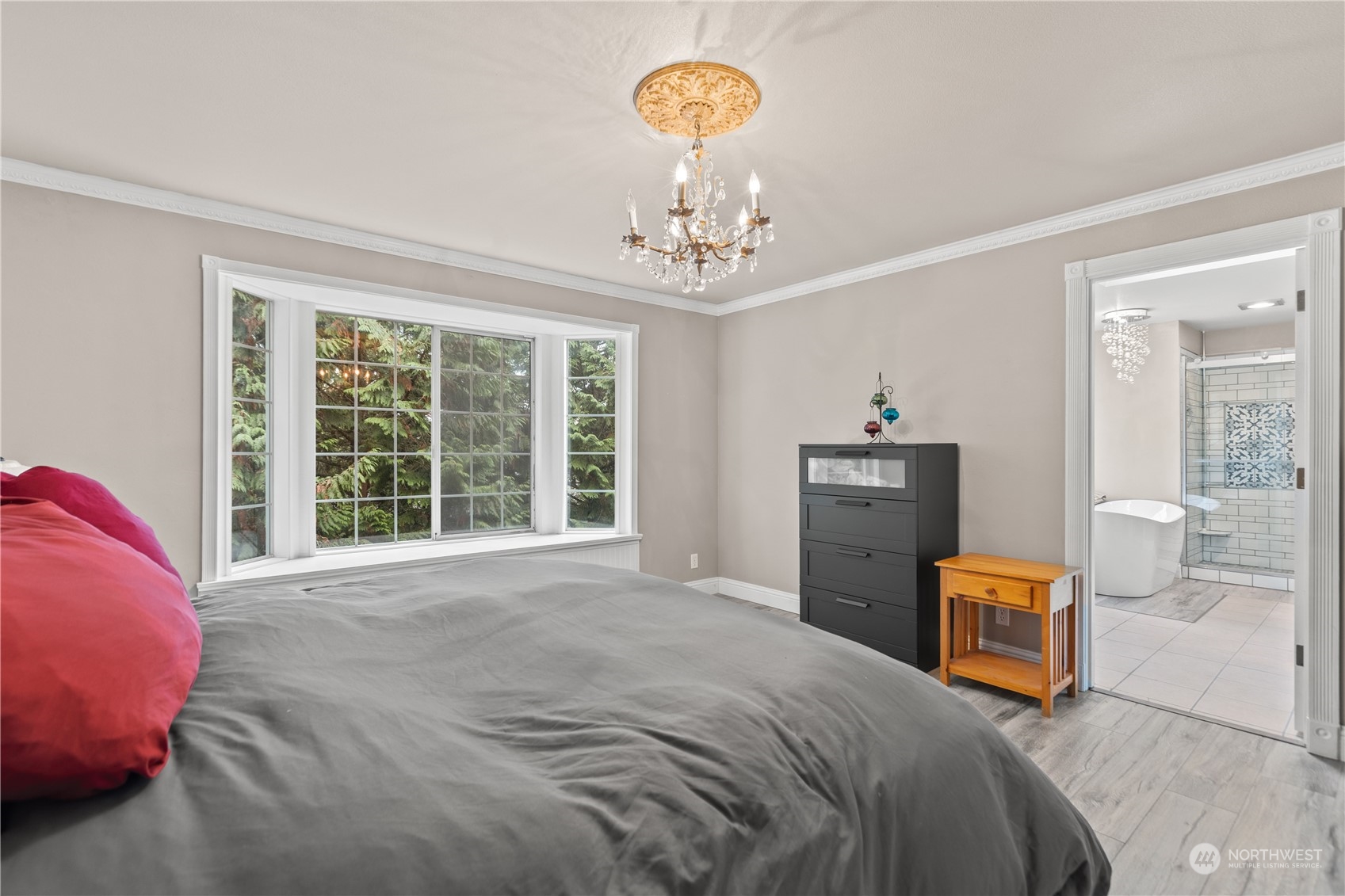 10411 Northeast 152nd Place Bothell, WA 98011 - Photo 23 of 38 a bedroom with a bed and a chandelier