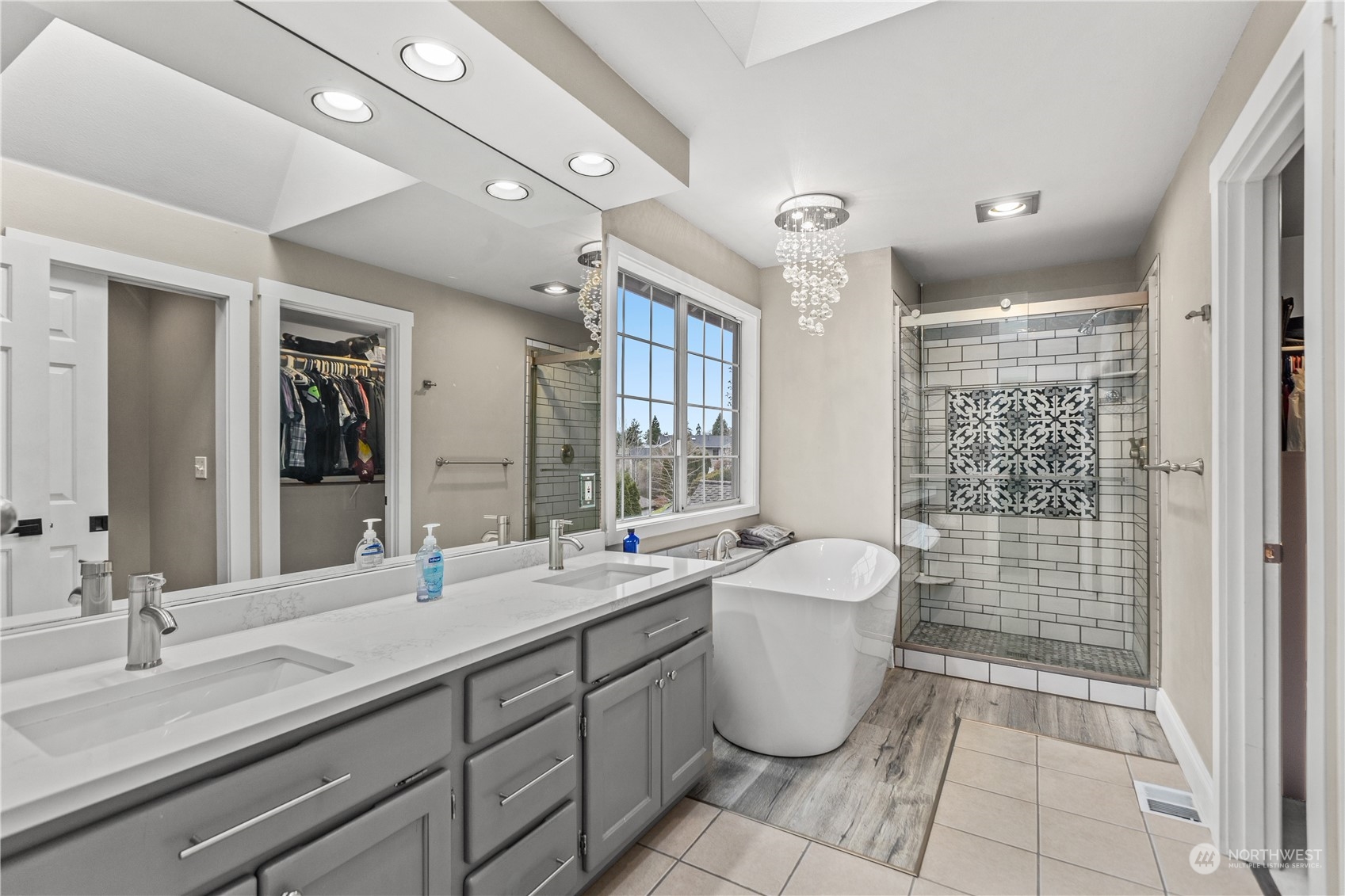 10411 Northeast 152nd Place Bothell, WA 98011 - Photo 24 of 38 a spacious bathroom with a double vanity sink a mirror and a bathtub