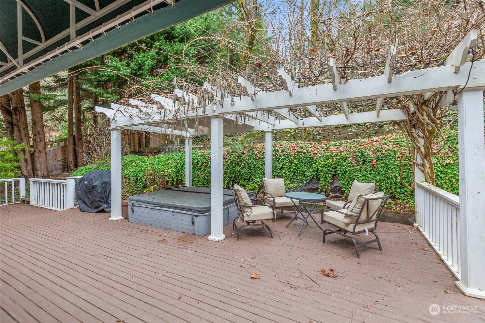 10411 Northeast 152nd Place Bothell, WA 98011 - Photo 33 of 38 a view of a patio with a table and chairs next to a yard