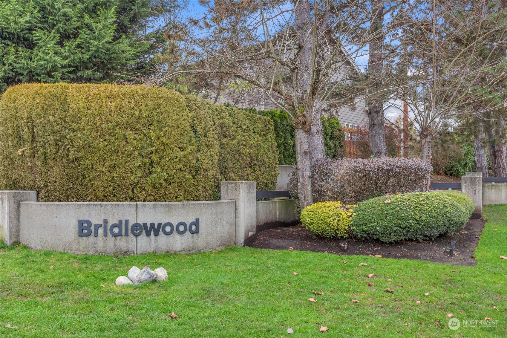 10411 Northeast 152nd Place Bothell, WA 98011 - Photo 38 of 38 a sign of golf club on a wall under a tree