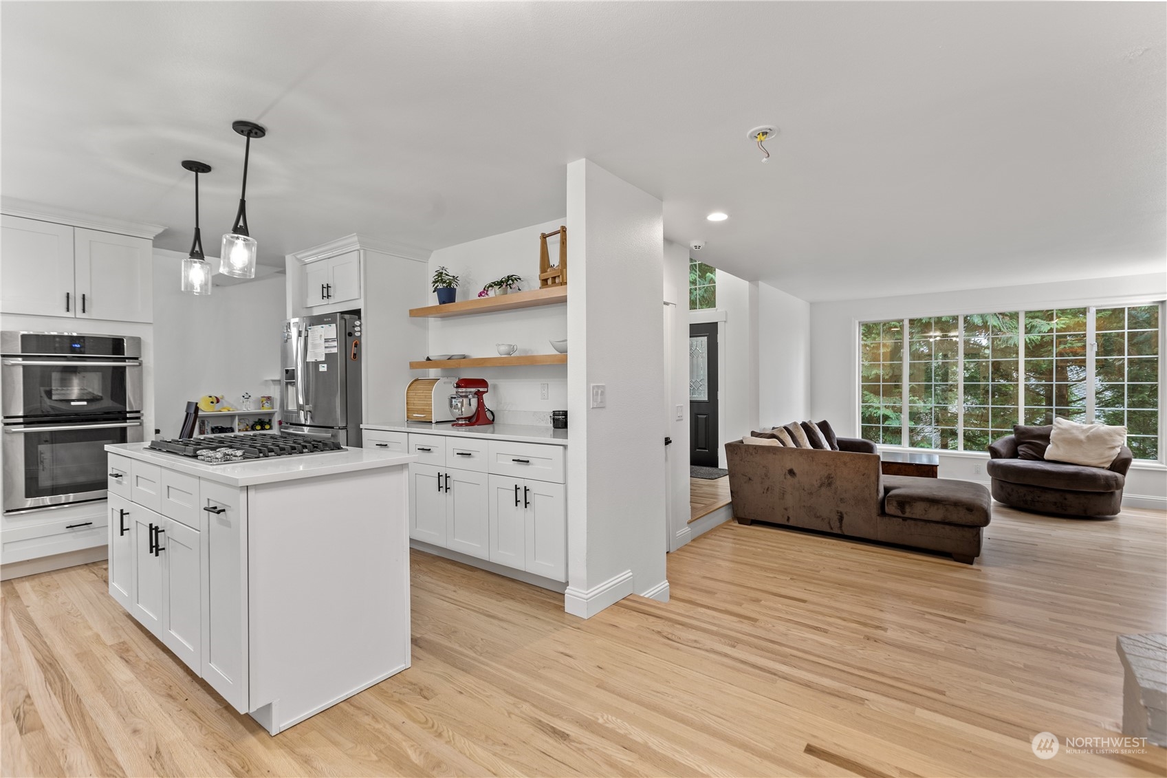 10411 Northeast 152nd Place Bothell, WA 98011 - Photo 9 of 38 a living room with kitchen island furniture and a wooden floor