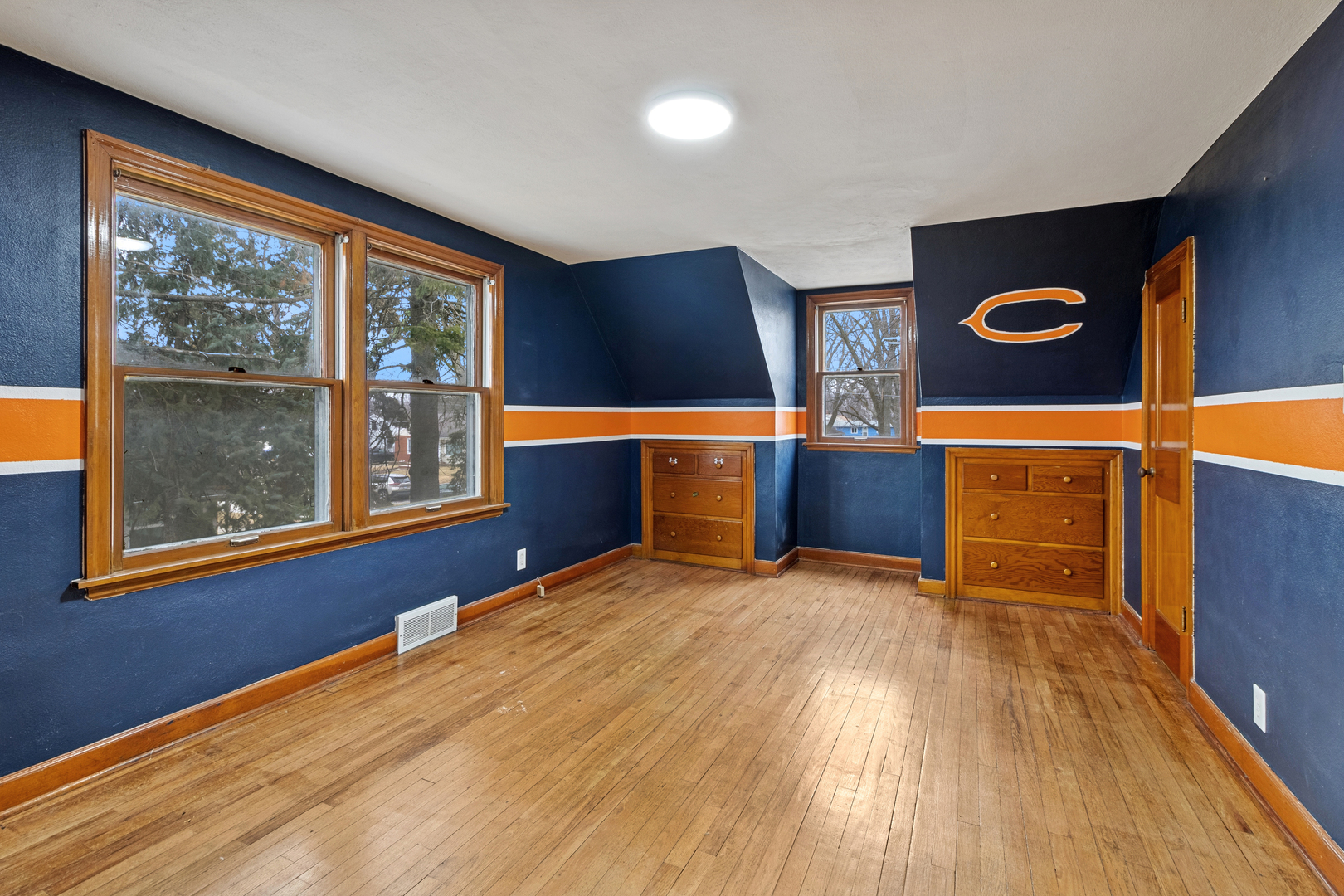 139 Elm Street DeKalb, IL 60115 - Photo 12 of 20 a view of an empty room with window and wooden floor