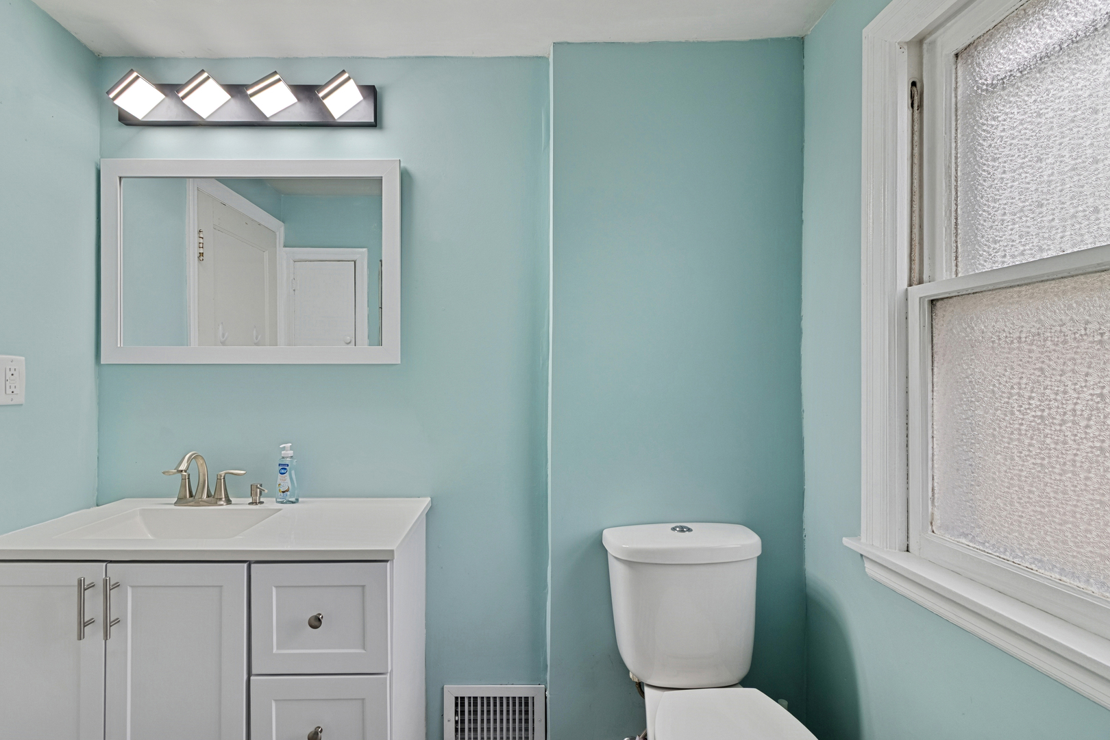 139 Elm Street DeKalb, IL 60115 - Photo 17 of 20 a bathroom with a sink mirror and toilet