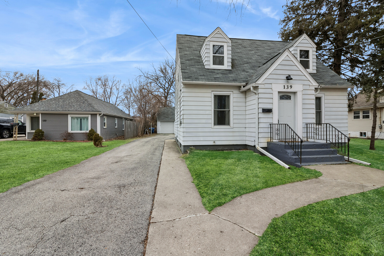 139 Elm Street DeKalb, IL 60115 - Photo 20 of 20 a front view of a house with a garden
