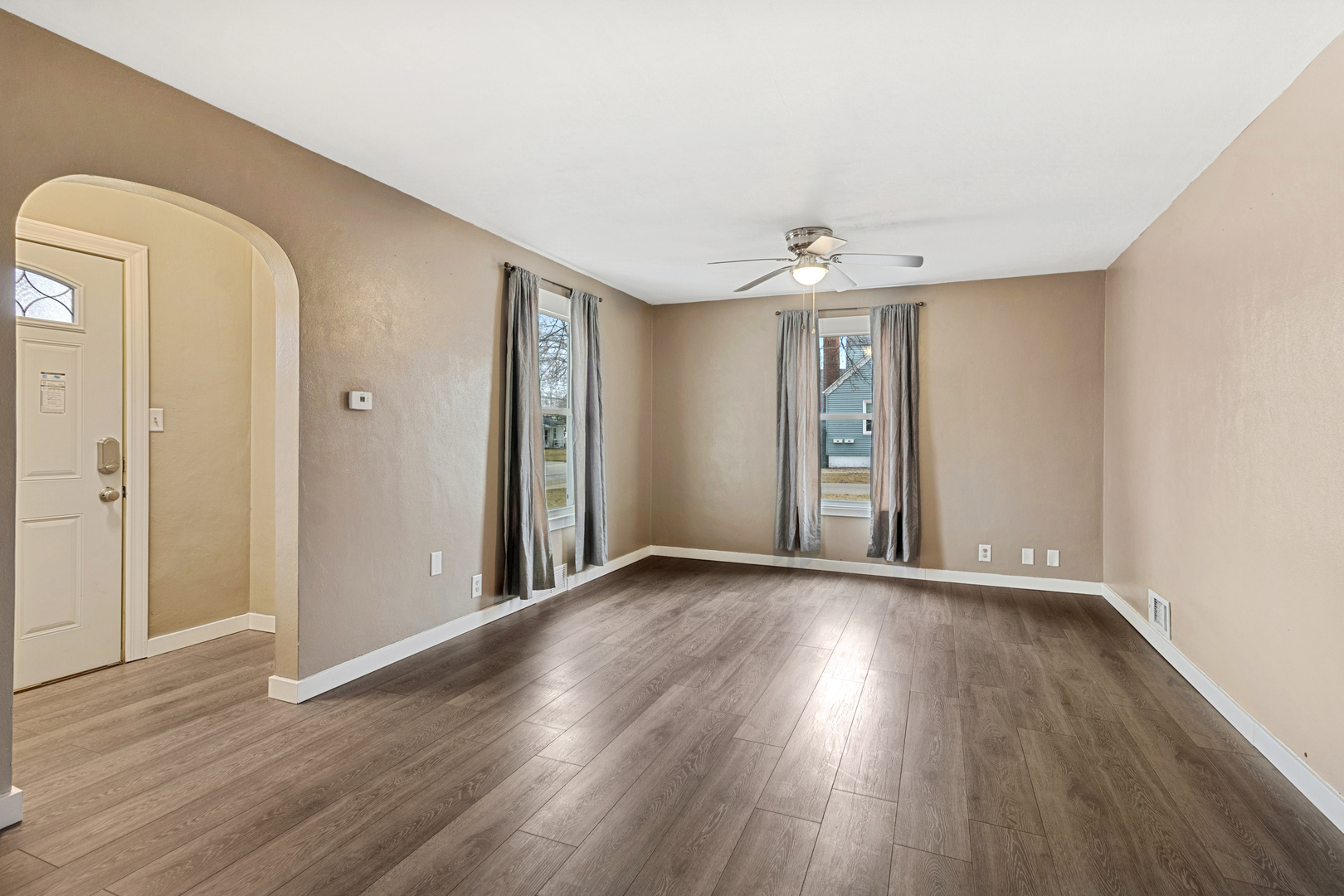 139 Elm Street DeKalb, IL 60115 - Photo 2 of 20 wooden floor in an empty room with a window