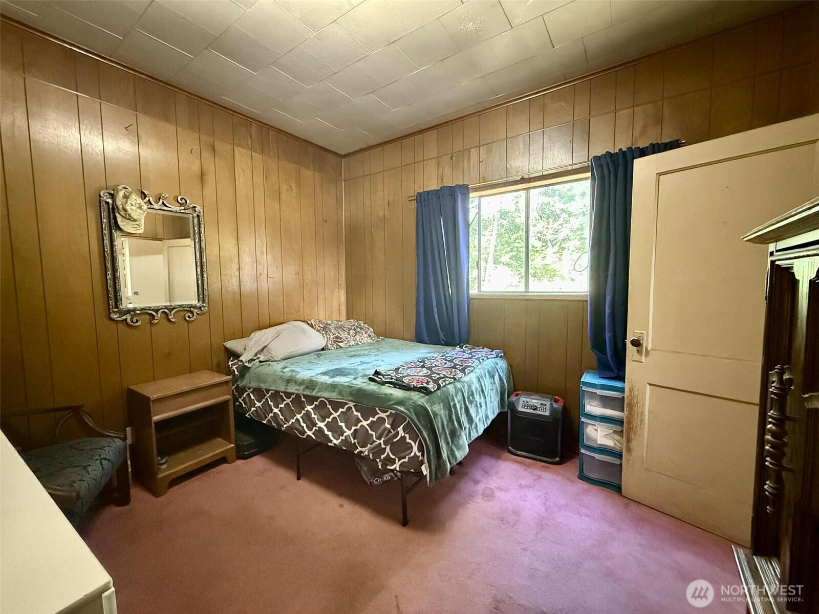 15 Heise Road South Elma, WA 98541 - Photo 15 of 40 a bedroom with a bed and a chandelier