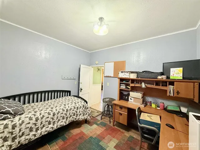 a bedroom with furniture and a window