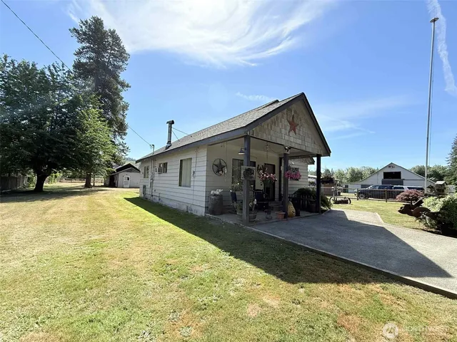 a front view of a house with yard patio and fire pit