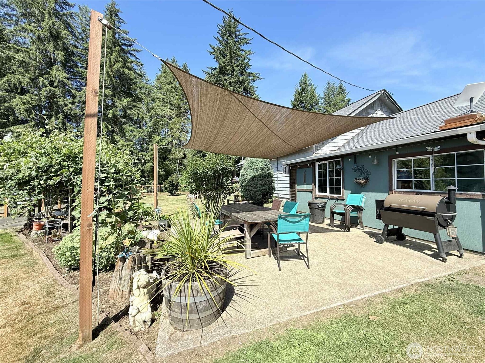 15 Heise Road South Elma, WA 98541 - Photo 23 of 40 a view of a patio with table and chairs potted plants with wooden fence
