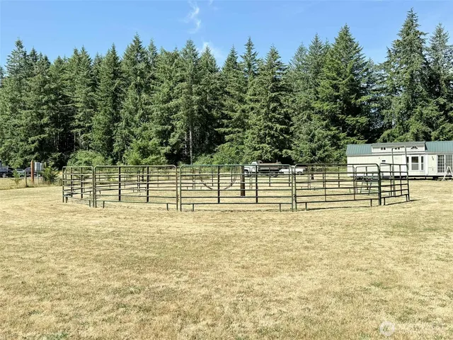 a view of a yard with wooden fence