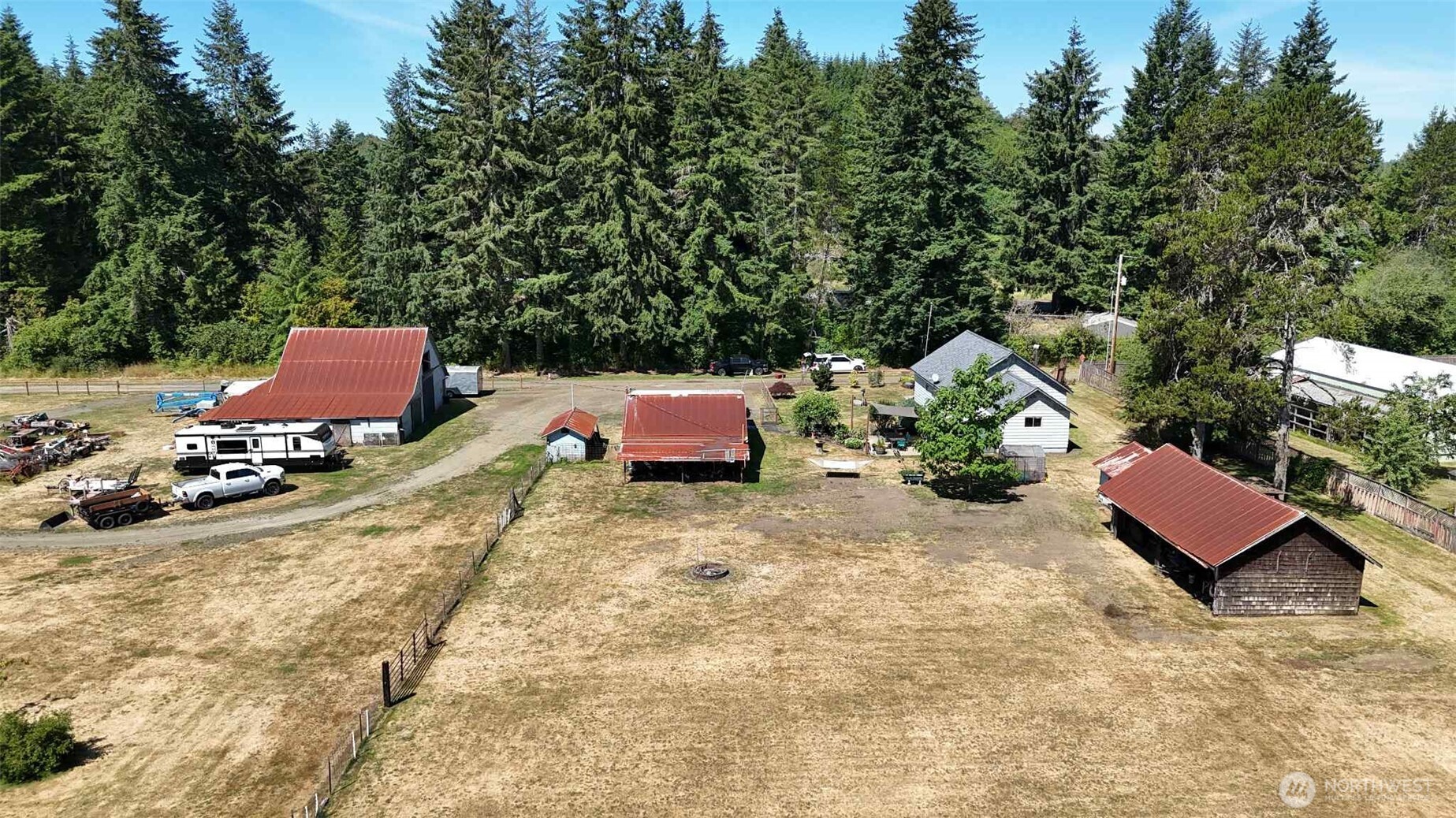 15 Heise Road South Elma, WA 98541 - Photo 37 of 40 a view of a backyard with table and chairs with wooden fence