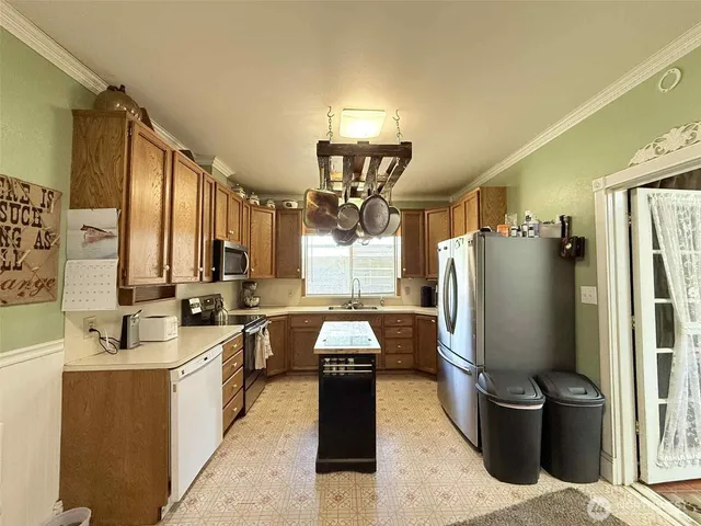 a kitchen with refrigerator and window