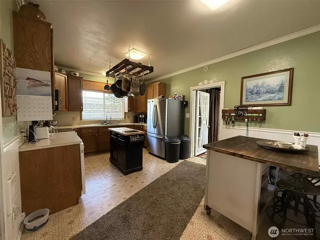 a kitchen with a sink stove and refrigerator