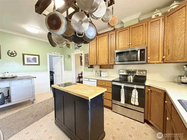 a kitchen with a stove cabinets and stainless steel appliances