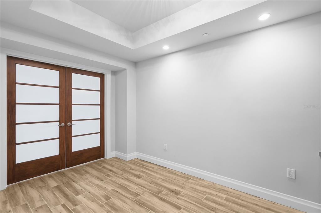 800 Collany Road, Unit 302 St. Petersburg, FL 33715 - Photo 22 of 66 a view of empty room with wooden floor and fan