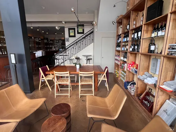 a dinning room with furniture a lamp and entryway
