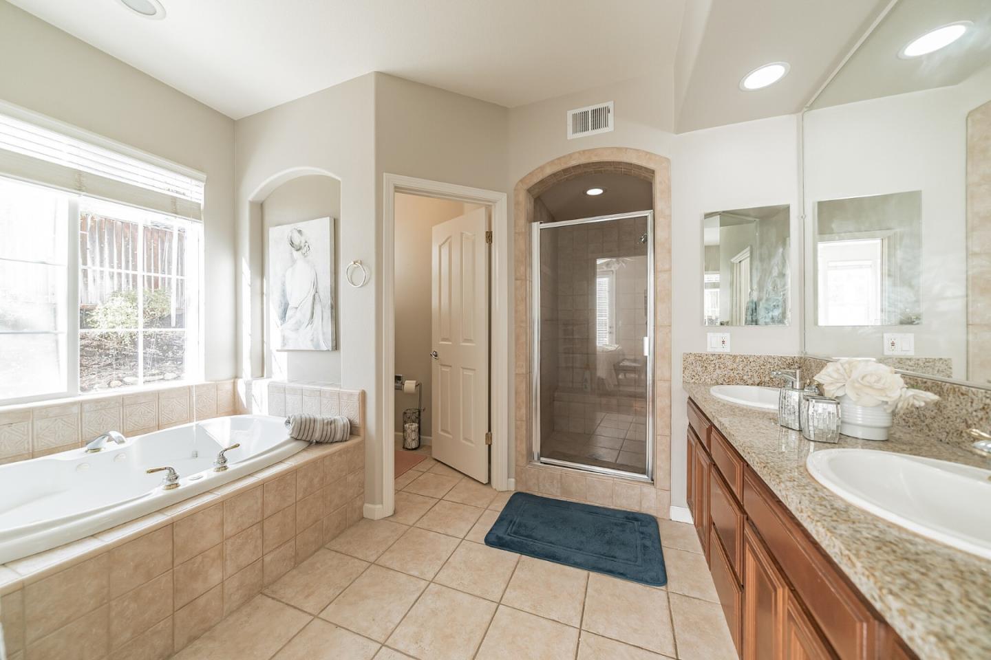 1193 South Chanterella Drive San Ramon, CA 94582 - Photo 18 of 45 a spacious bathroom with a granite countertop tub mirror and shower