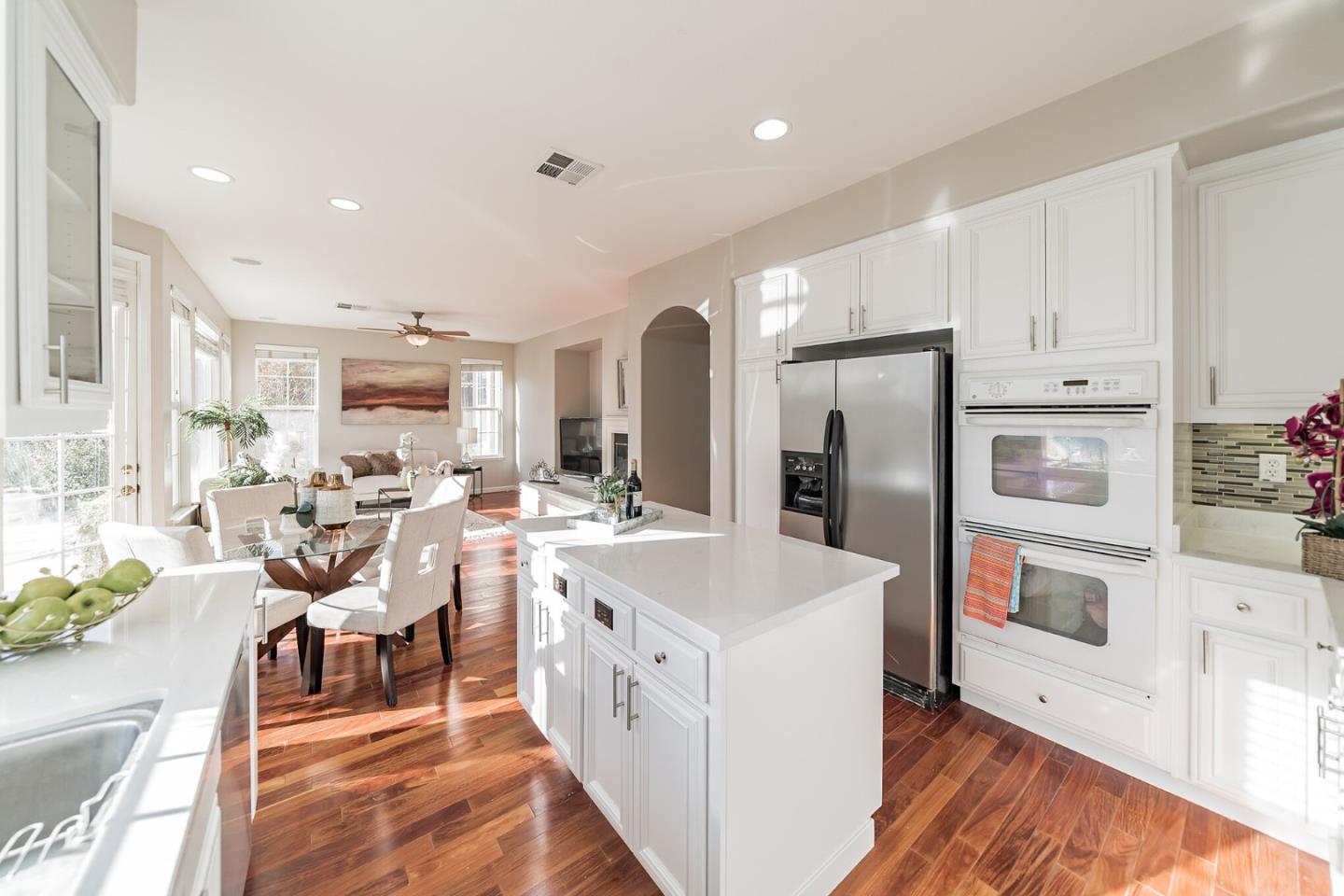 1193 South Chanterella Drive San Ramon, CA 94582 - Photo 27 of 45 a kitchen with a sink a refrigerator and chairs