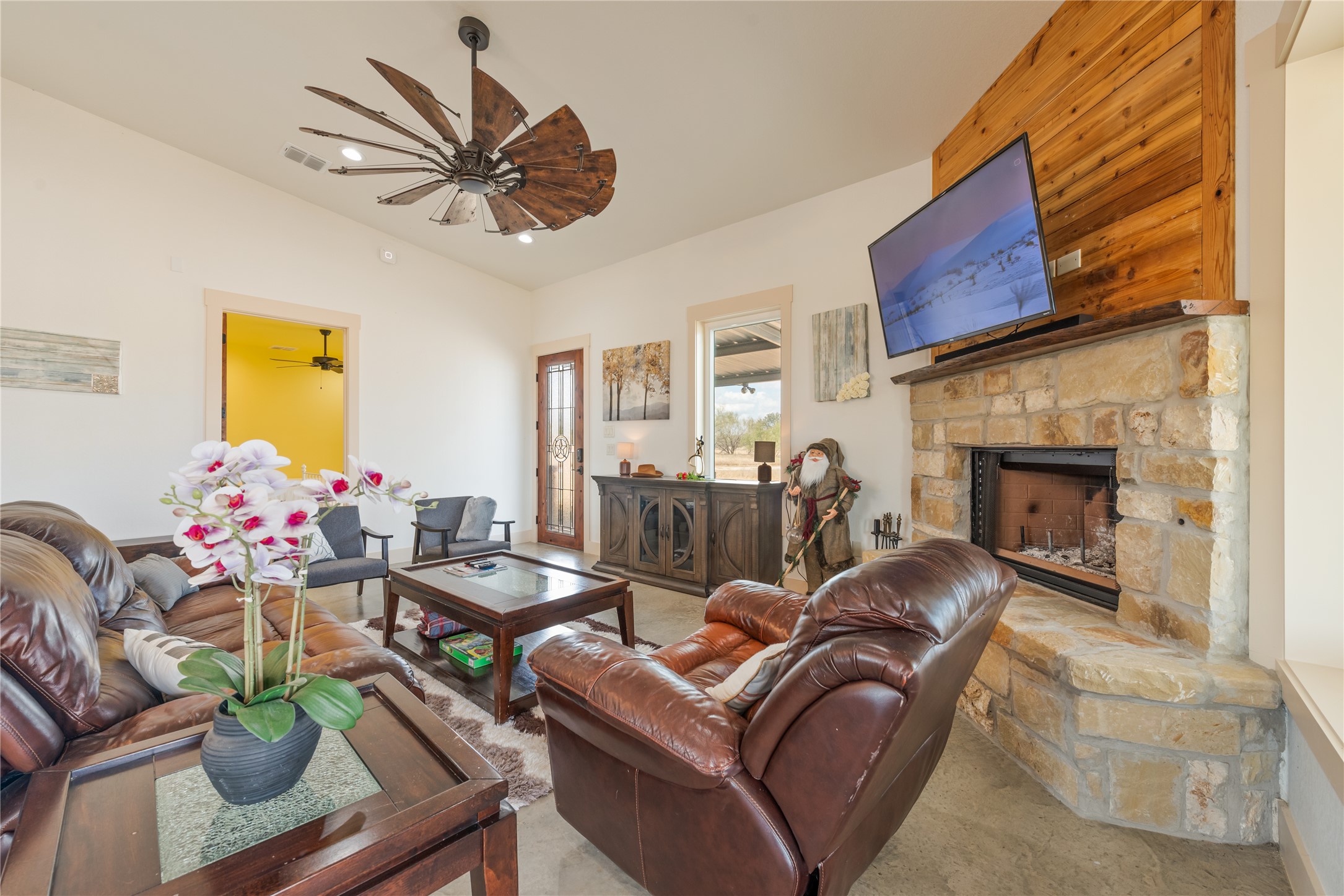 928 Bendele Road Johnson City, TX 78636 - Photo 11 of 31 a living room with furniture a chandelier and a fireplace
