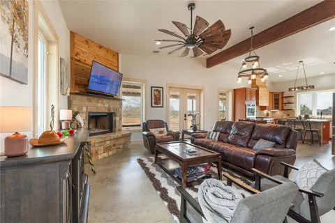 a living room with furniture a fireplace and a flat screen tv