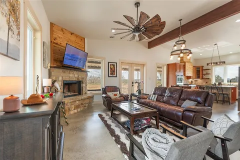 a living room with furniture a fireplace and a flat screen tv