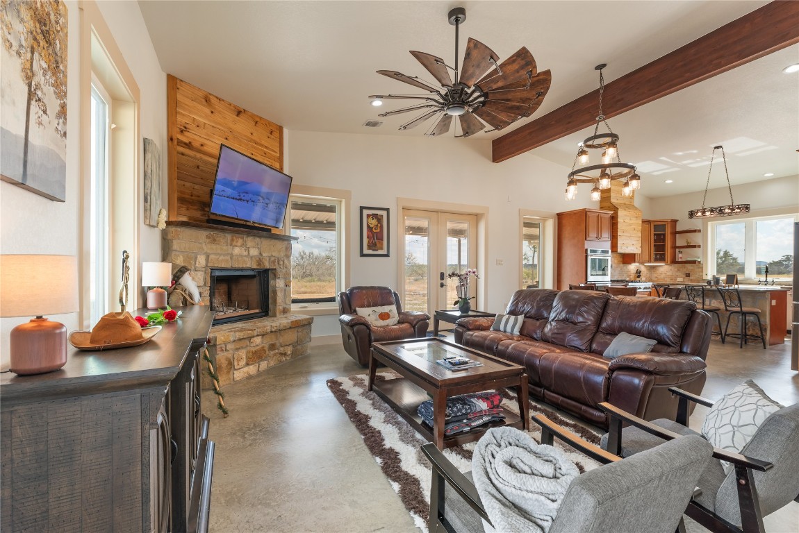 928 Bendele Road Johnson City, TX 78636 - Photo 12 of 31 a living room with furniture a fireplace and a flat screen tv