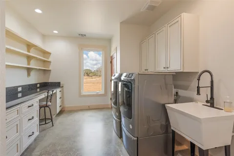 a kitchen with a sink appliances and cabinets